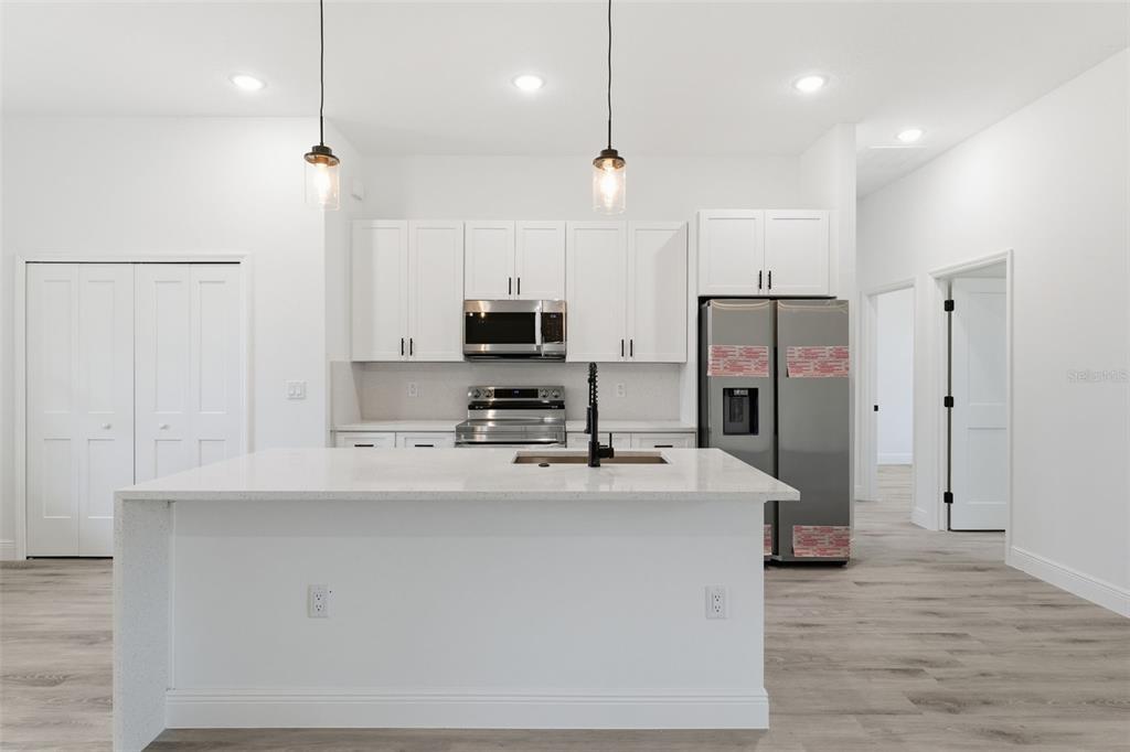 4473 Southwest 168th Lane Ocala, FL 34473 - Photo 10 of 33 a kitchen with stainless steel appliances a refrigerator sink and microwave
