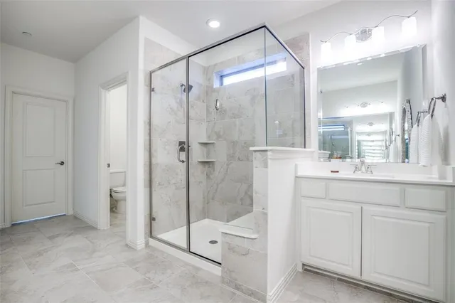 a bathroom with a shower sink and mirror