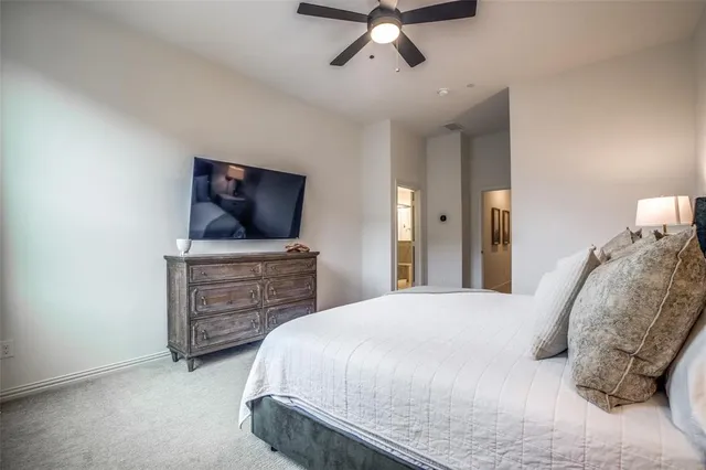 a bedroom with a bed and flat screen tv