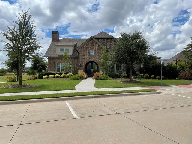 a view of a house with a big yard and large trees