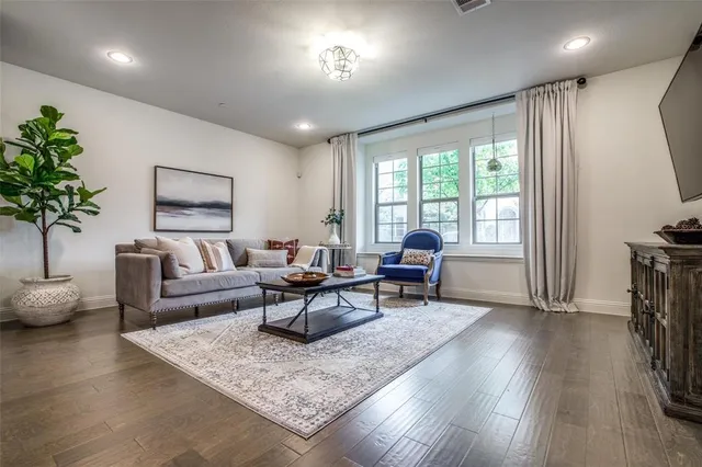 a living room with furniture and a potted plant