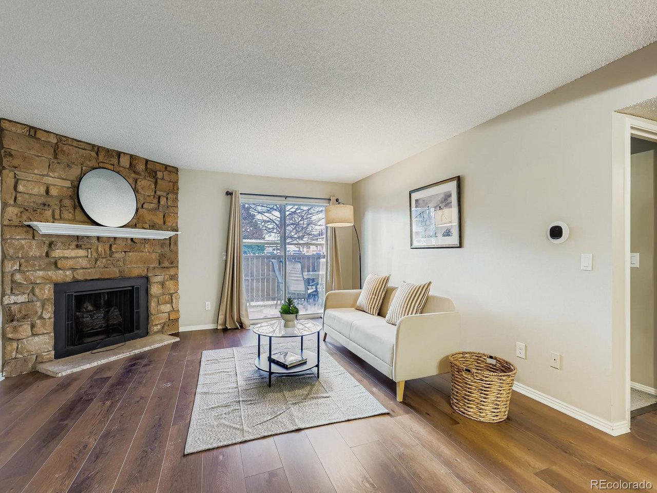 10251 West 44th Avenue, Unit 106 Wheat Ridge, CO 80033 - Photo 1 of 17 a living room with furniture and a fireplace