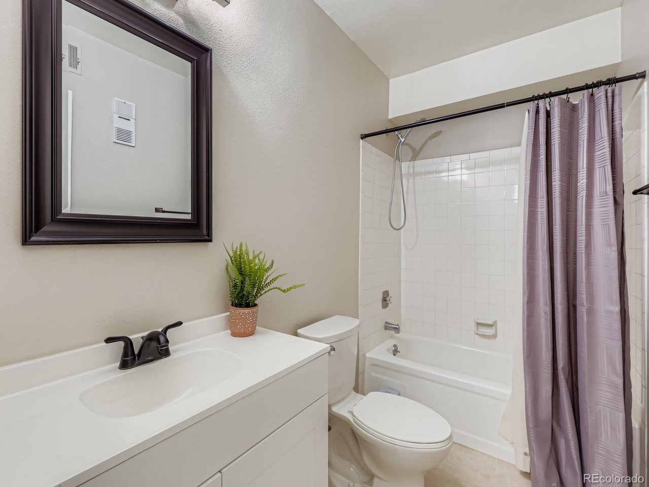 10251 West 44th Avenue, Unit 106 Wheat Ridge, CO 80033 - Photo 11 of 17 a bathroom with a sink toilet and shower