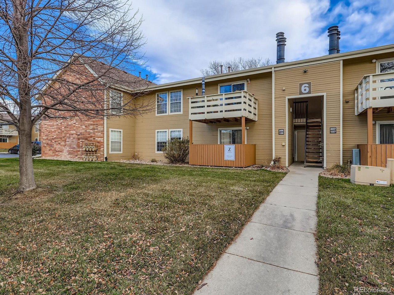 10251 West 44th Avenue, Unit 106 Wheat Ridge, CO 80033 - Photo 2 of 17 a front view of house with yard