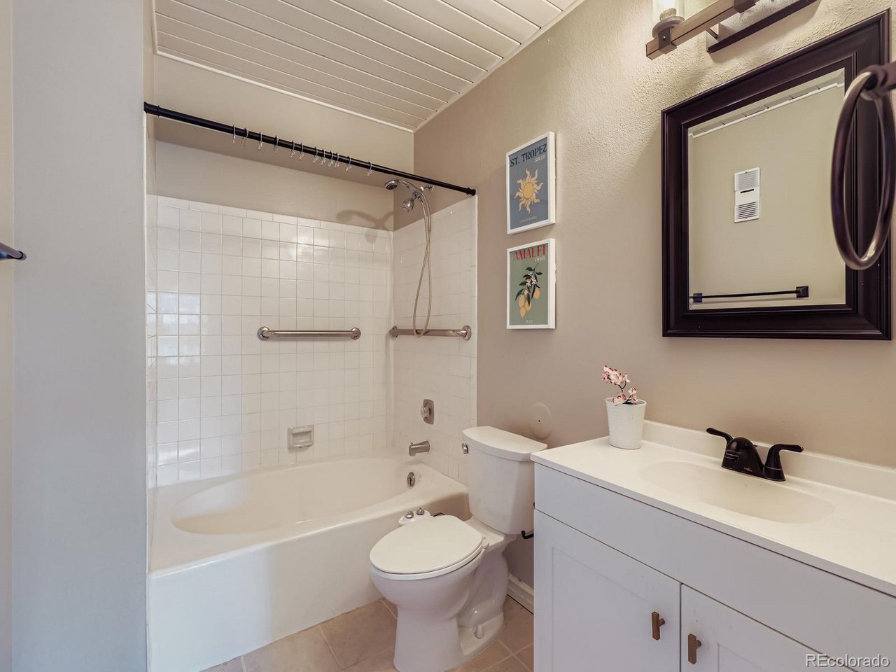 10251 West 44th Avenue, Unit 106 Wheat Ridge, CO 80033 - Photo 6 of 17 a bathroom with a sink toilet and shower