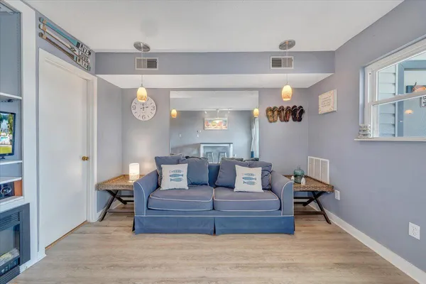a living room with furniture and a wooden floor