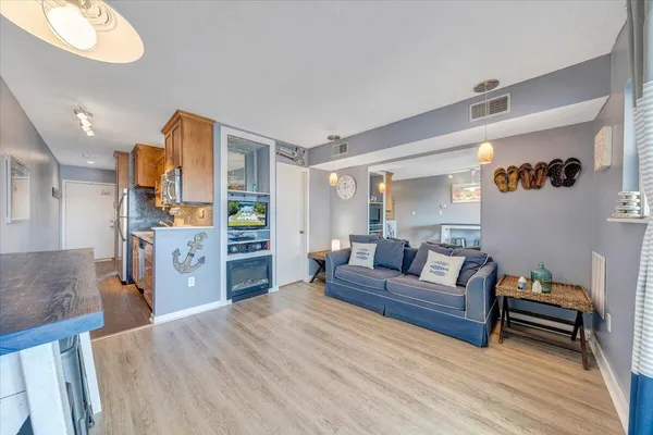 a living room with furniture and a wooden floor