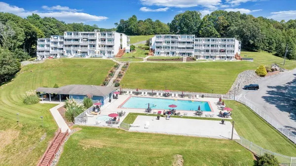 a view of swimming pool with a garden and seating area