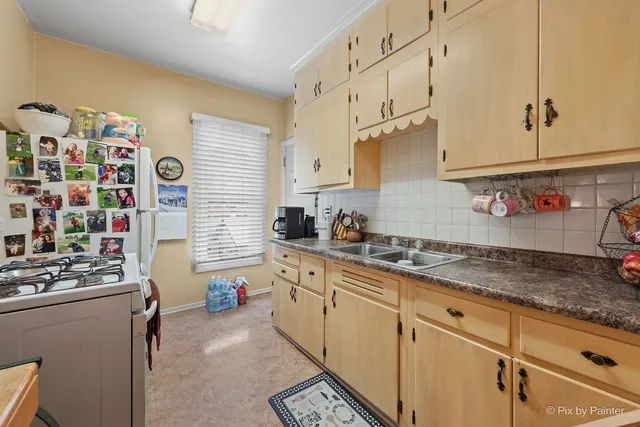 a front view of a house with cars parked