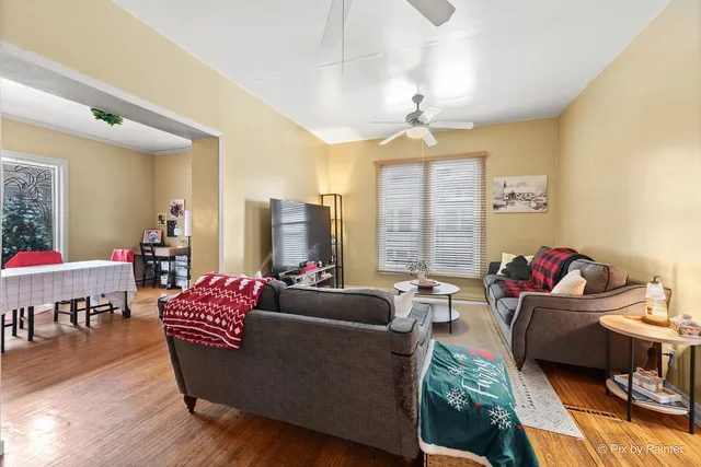 a living room with furniture and a dining table with kitchen view