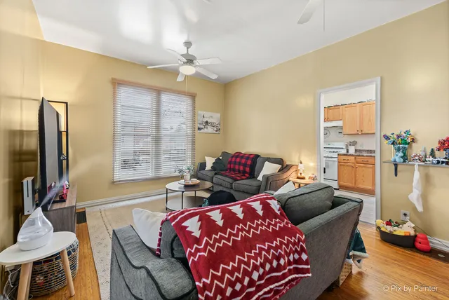 a kitchen with stainless steel appliances granite countertop a lot of cabinets and wooden floor