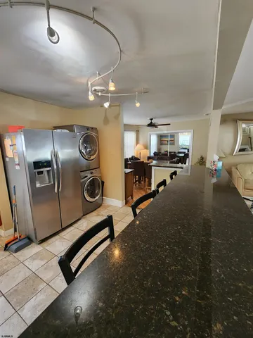 a bathroom with a granite countertop toilet sink and mirror