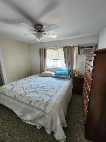 a bedroom with a bed couch and window