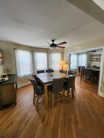 a view of a dining room with furniture and wooden floor