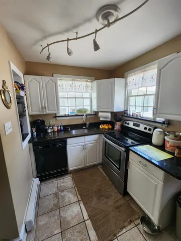 a kitchen with a sink a stove a refrigerator and window