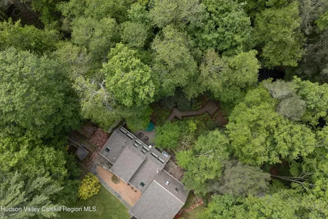 an aerial view of a house with a yard