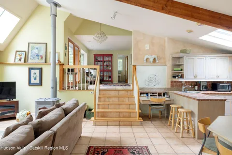 a living room with furniture and a kitchen view