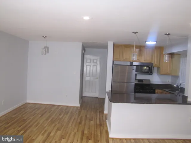 a large kitchen with cabinets and stainless steel appliances