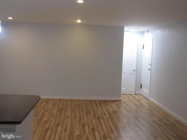 a view of room with wooden floor