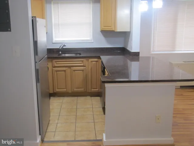 a bathroom with a granite countertop sink a mirror and a bathtub