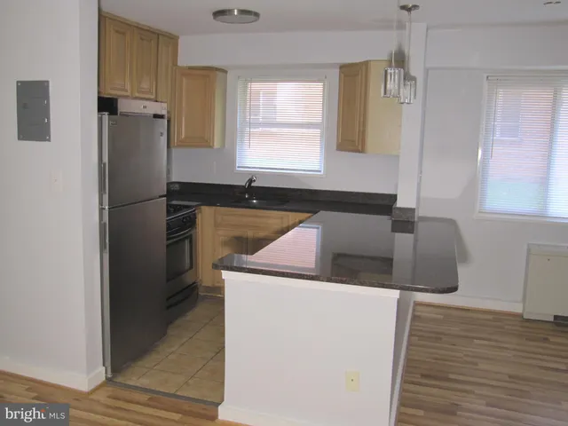 a kitchen with a refrigerator sink and stove