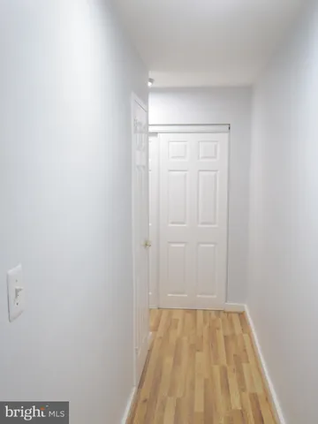 a view of a room with wooden floor and bathroom