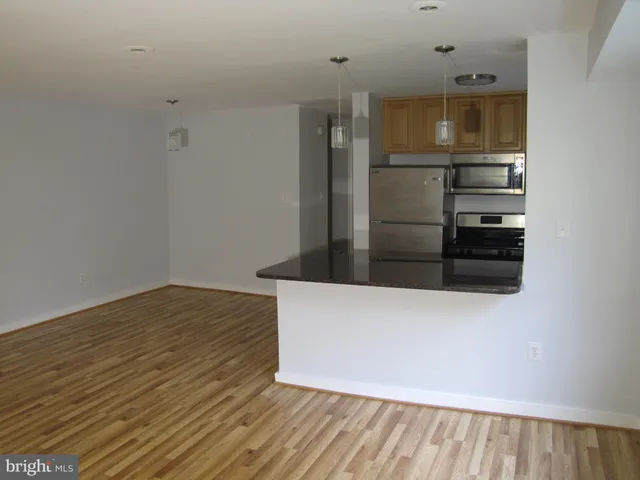a view of kitchen and wooden floor