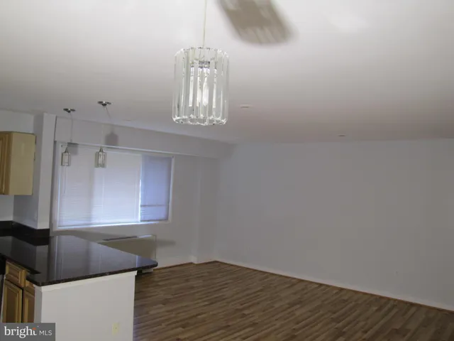 a kitchen with cabinets and a wooden floor