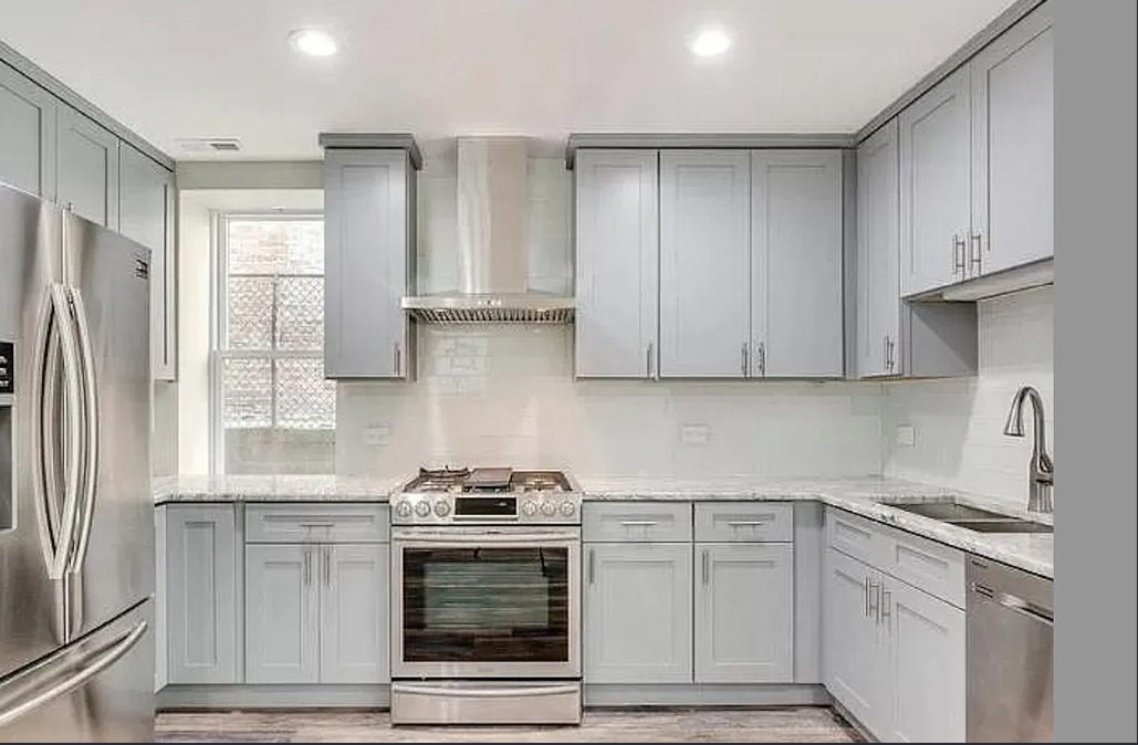 1930 South Morgan Street, Unit 1 Chicago, IL 60608 - Photo 3 of 11 a kitchen with stainless steel appliances white cabinets and a stove top oven