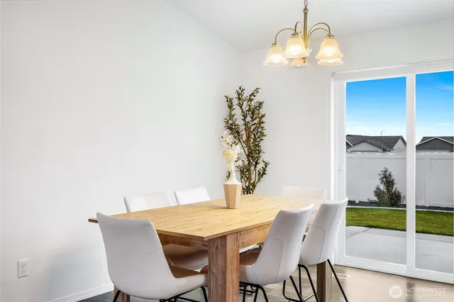 a view of a dining room with furniture and chandelier