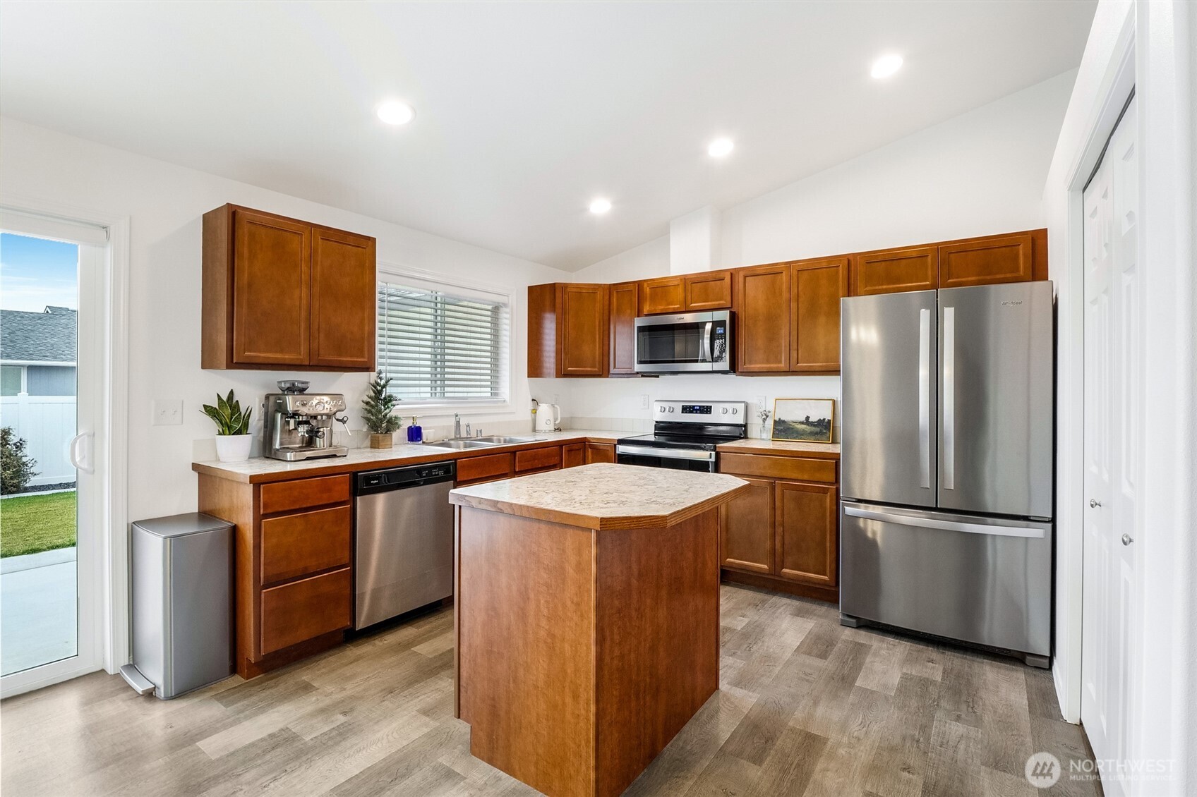 1313 Polo Ridge Moses Lake, WA 98837 - Photo 13 of 37 a kitchen with stainless steel appliances granite countertop a refrigerator stove a sink dishwasher and a refrigerator with wooden floor