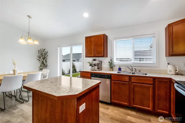a kitchen with a sink a counter space and wooden floor