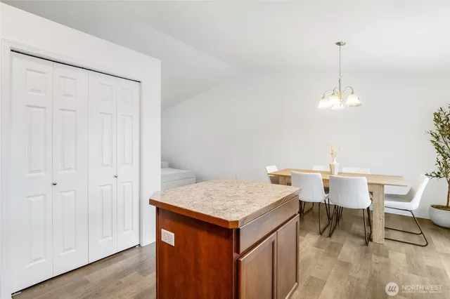 a view of a room with a table and chairs