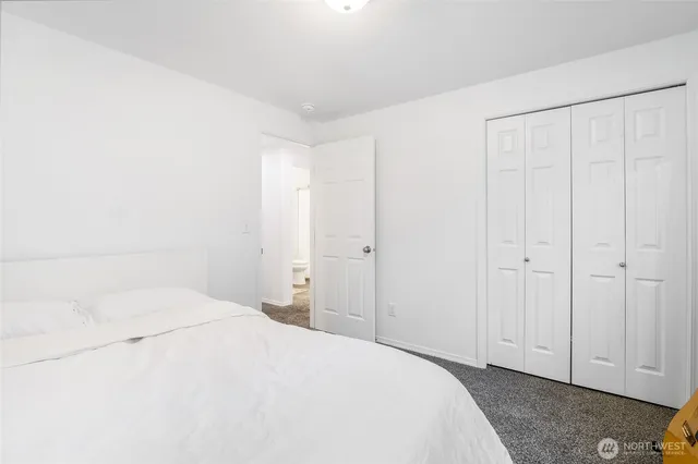 a large white bed in a white room