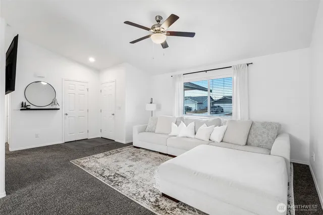 a living room with furniture and a large window