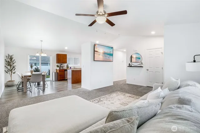 a living room with furniture and kitchen view