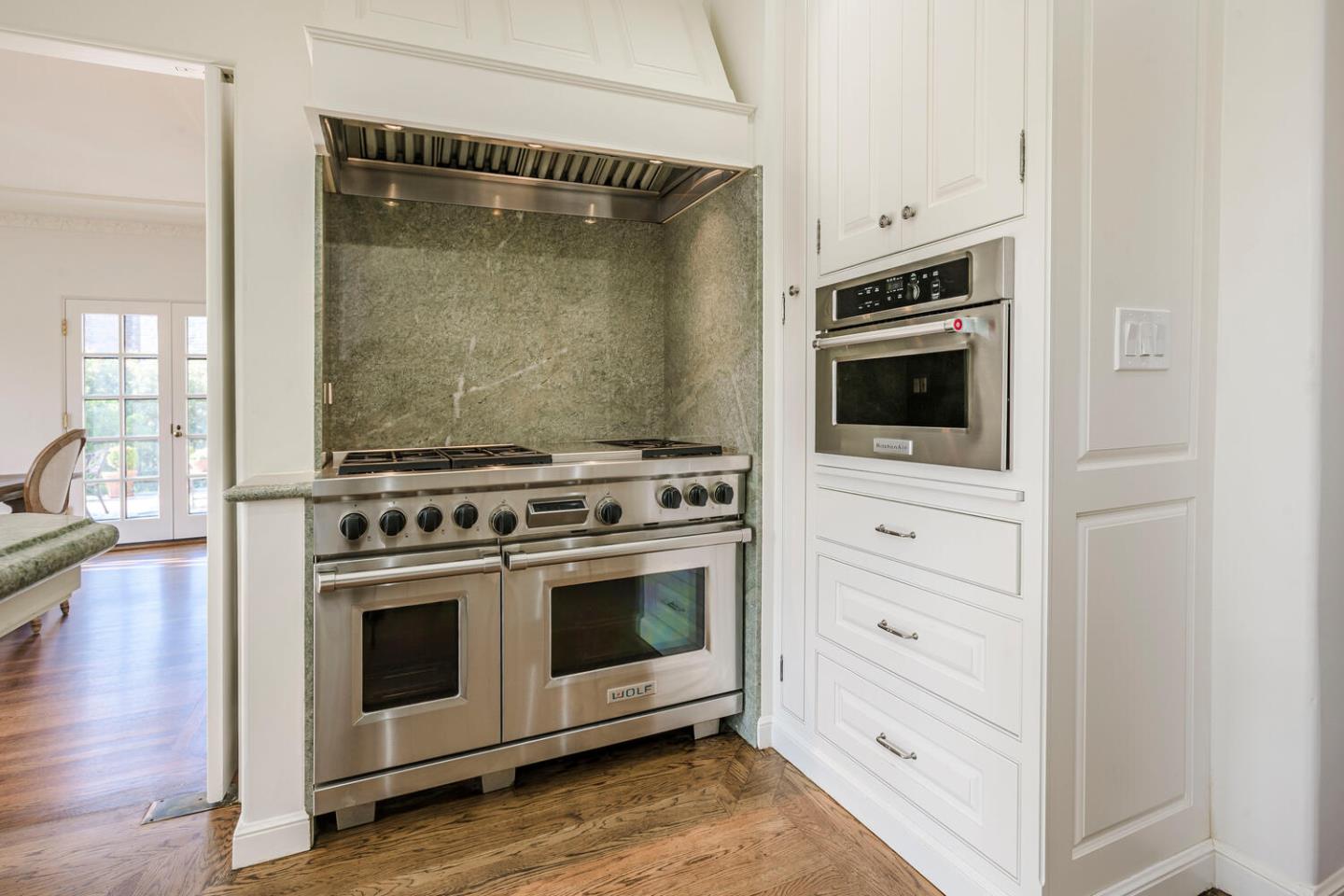 595 Hayne Road Hillsborough, CA 94010 - Photo 13 of 71 a kitchen with a stove and white cabinets