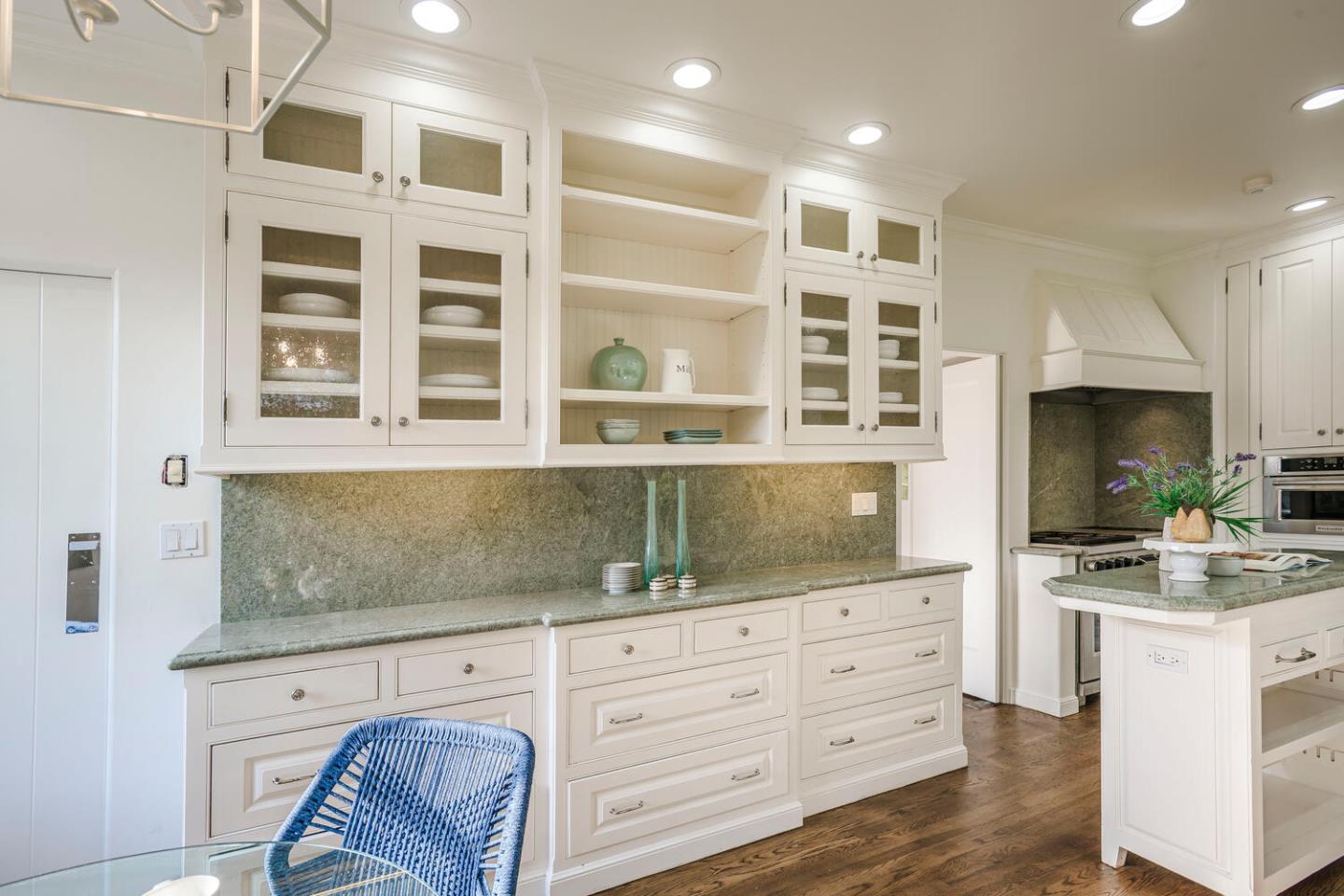 595 Hayne Road Hillsborough, CA 94010 - Photo 15 of 71 a kitchen with stainless steel appliances kitchen island granite countertop a stove and a sink