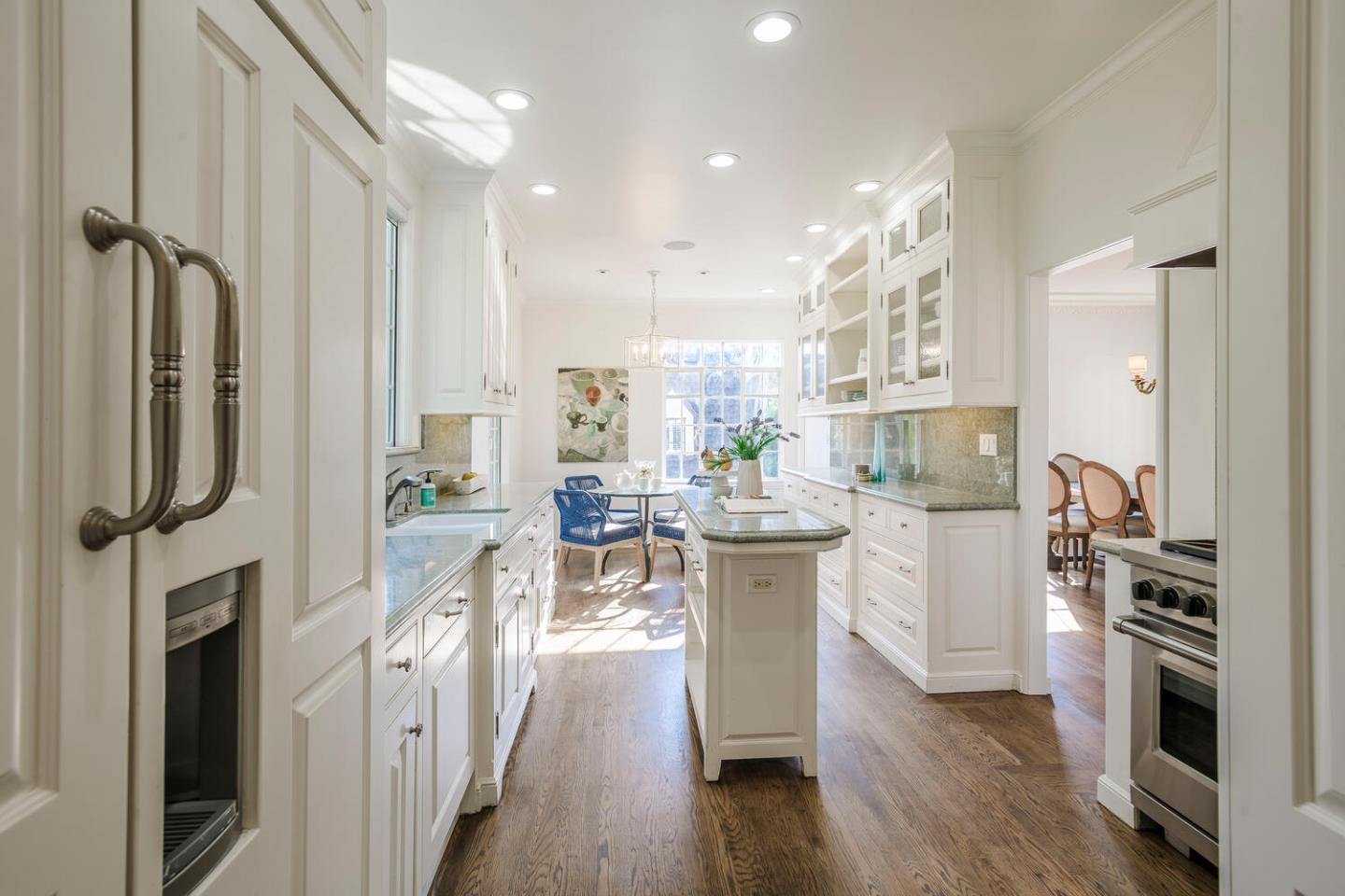 595 Hayne Road Hillsborough, CA 94010 - Photo 37 of 71 a kitchen with stainless steel appliances granite countertop a refrigerator a oven a sink and white cabinets with wooden floor