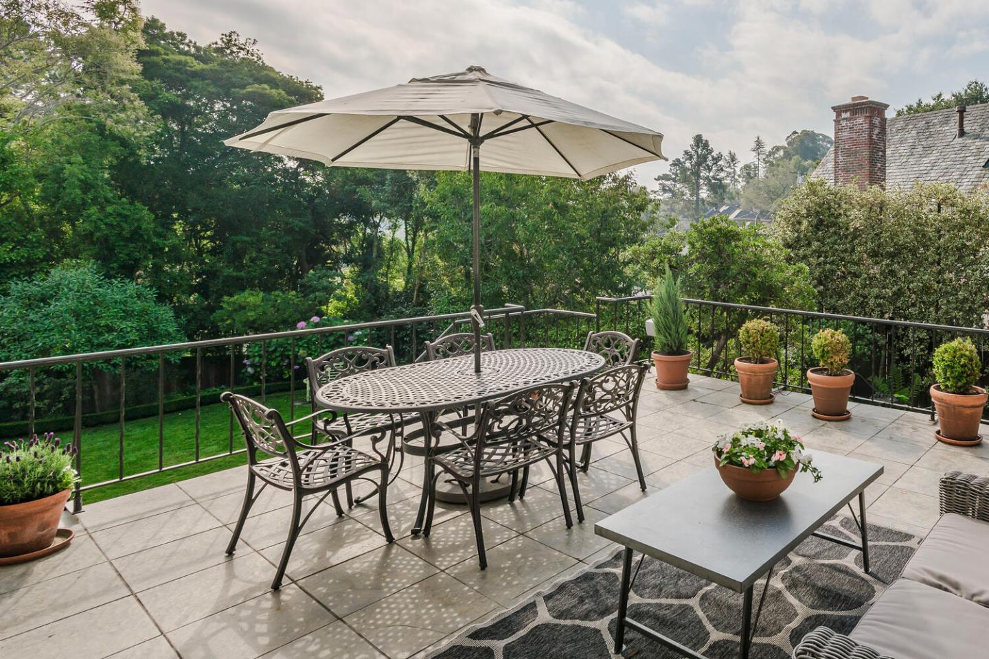 595 Hayne Road Hillsborough, CA 94010 - Photo 58 of 71 a roof deck with table and chairs under an umbrella