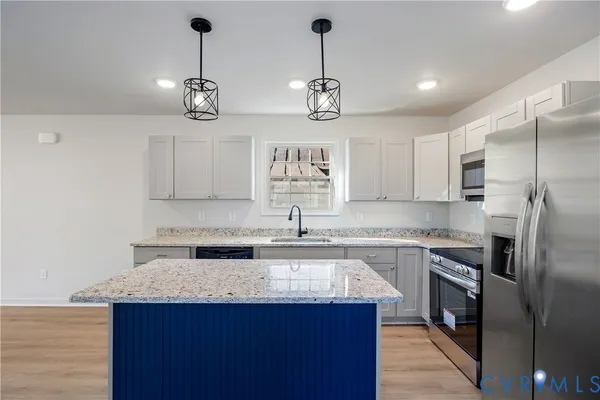 a kitchen with a center island and cabinets