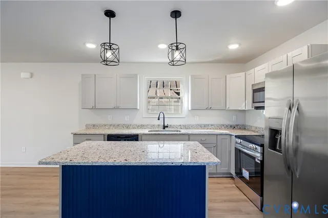 a kitchen with a center island and cabinets