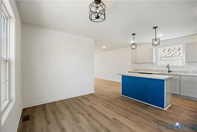 a view of kitchen with sink and wooden floor