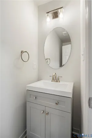 a bathroom with a sink vanity and a mirror