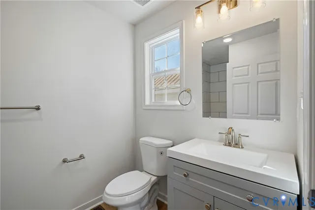 a bathroom with a sink a toilet and mirror