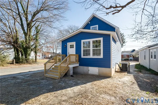a view of a house with a yard covered in snow