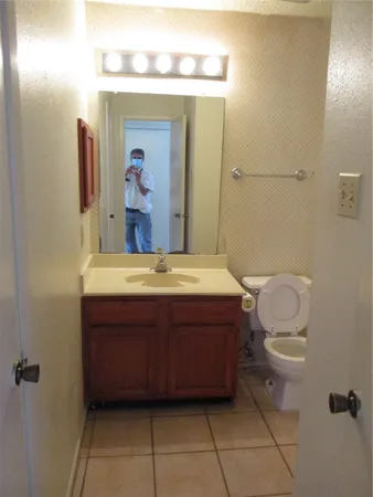 a bathroom with a sink a toilet and mirror