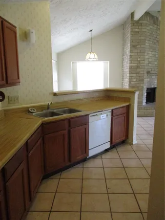 a view of a kitchen with a sink and cabinets
