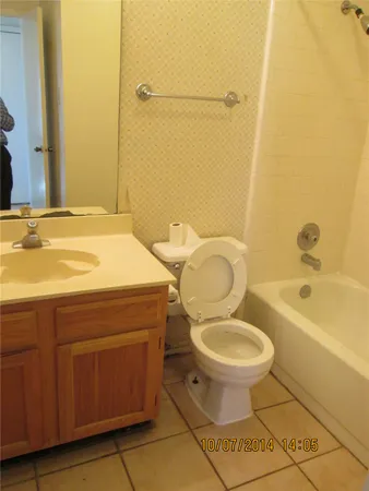a bathroom with a sink a toilet and bathtub