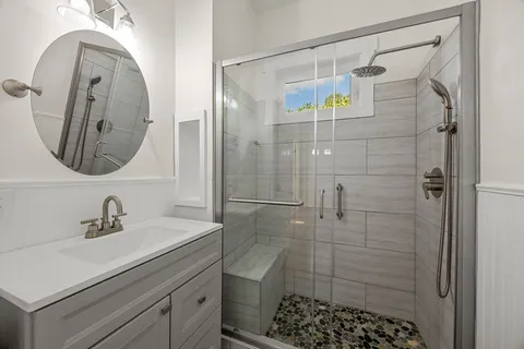 a bathroom with a shower and a sink
